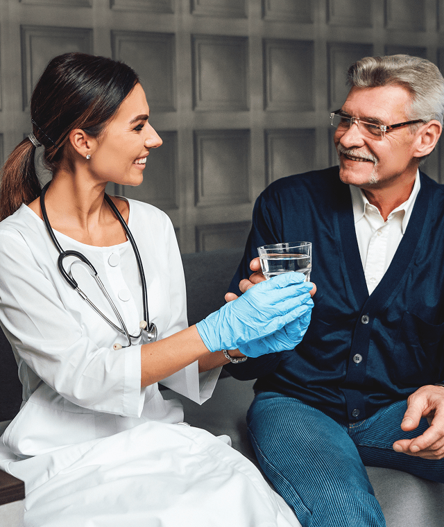 Doctor assisting elderly patient with care and support in a medical clinic.