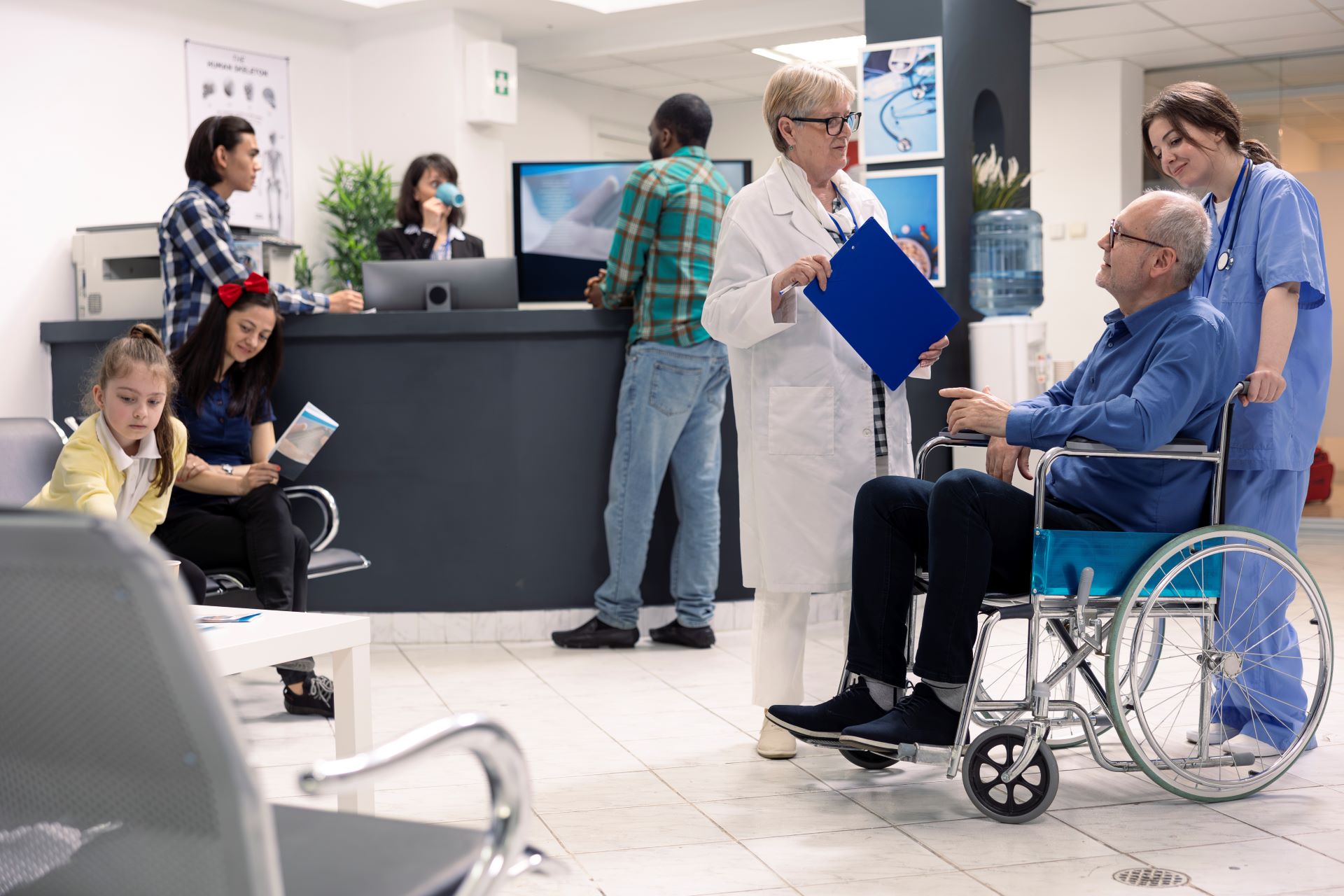 Healthcare provider consulting with a senior patient in a wheelchair.
