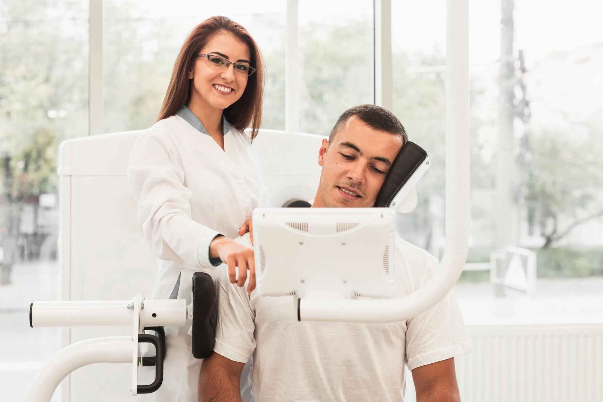 Provider showing a patient a body contouring device during a consultation